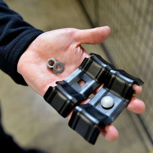 Closeup of Perimeter Patrol panel hardware clamp in black powder-coated steel